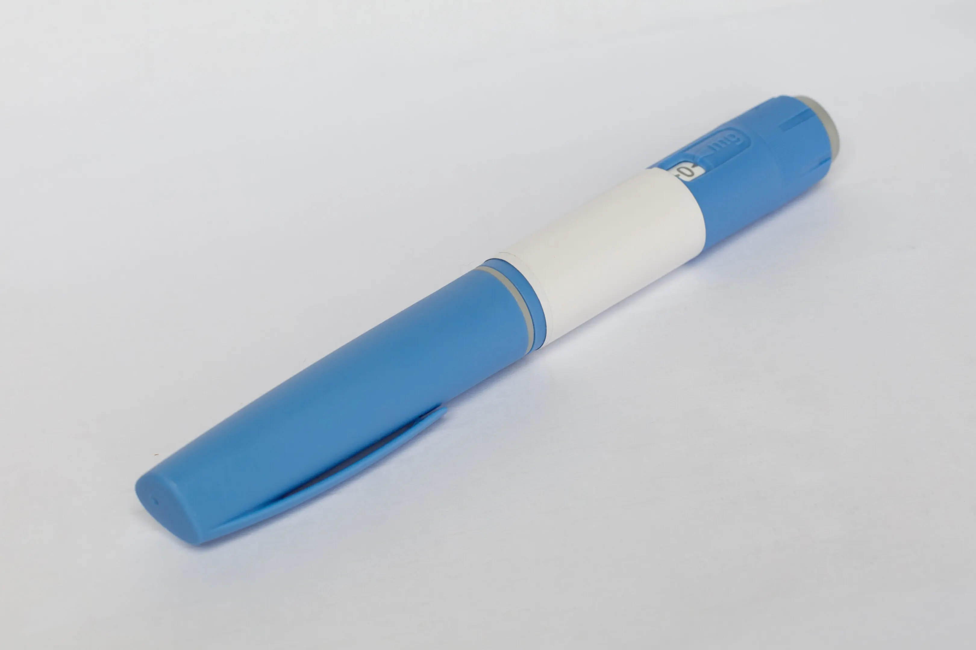 A blue pen with white writing on it.